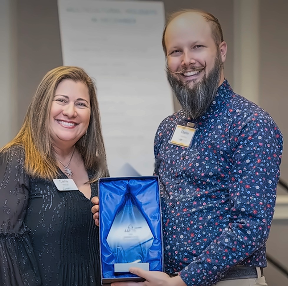 Charles holding his Kindness Award at the AAFCPAs celebration